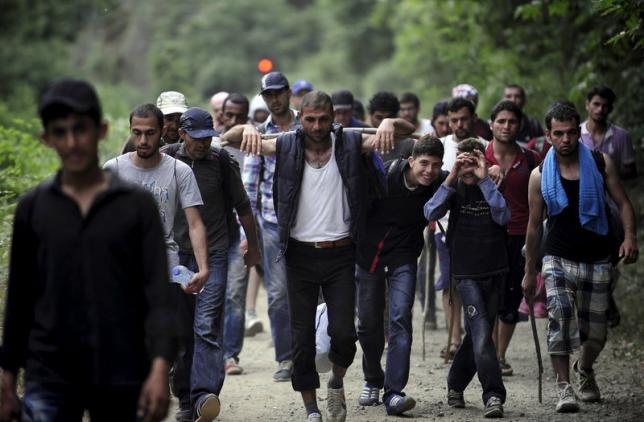 Migrants from Syria walk in Macedonia near the Greek border